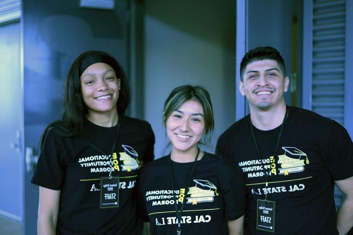 Three people smiling and wearing t-shirts for the Educational Opportunity Program.